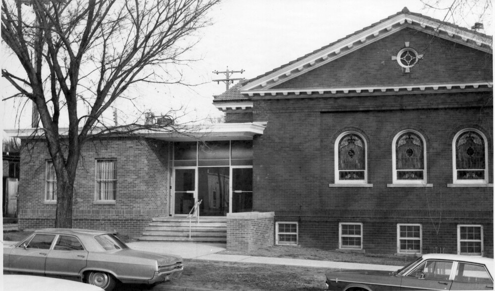 brick building with steps into addition to building