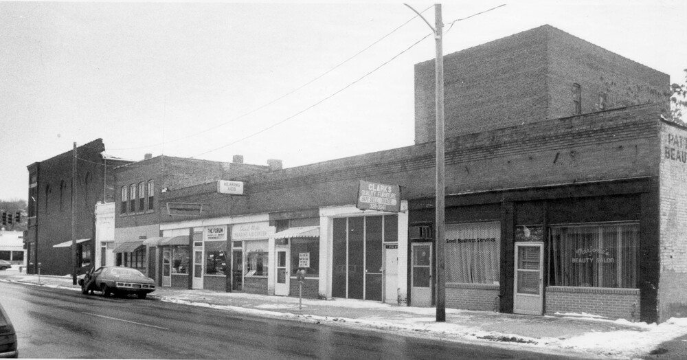 city block of old brick buildings, with updated fronts