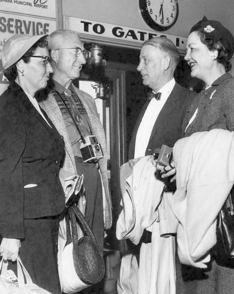 Two couples near an airline gate.