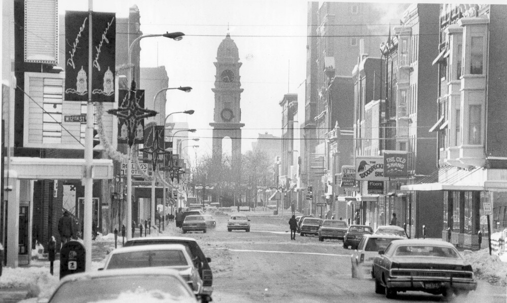 winter view down downtown street toward a clock tower