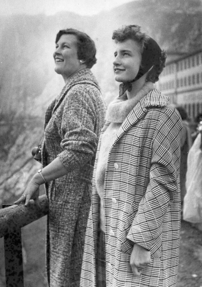 Two smiling women looking upward.