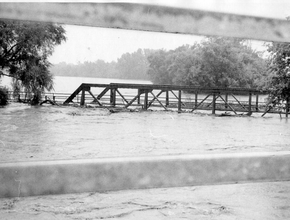 Bridge surrounded by flood waters.