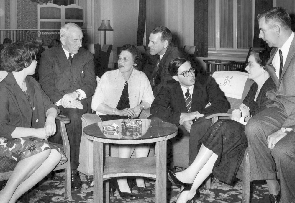 A group of people chatting near a table.
