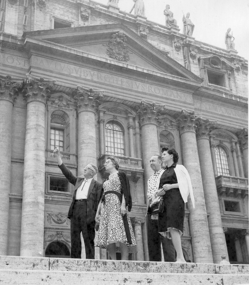 Two couples in front of a church.