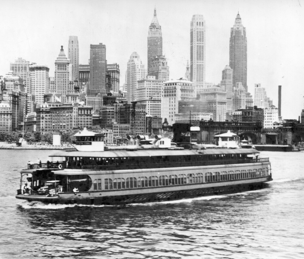 Ferry boat in front of a city scape.