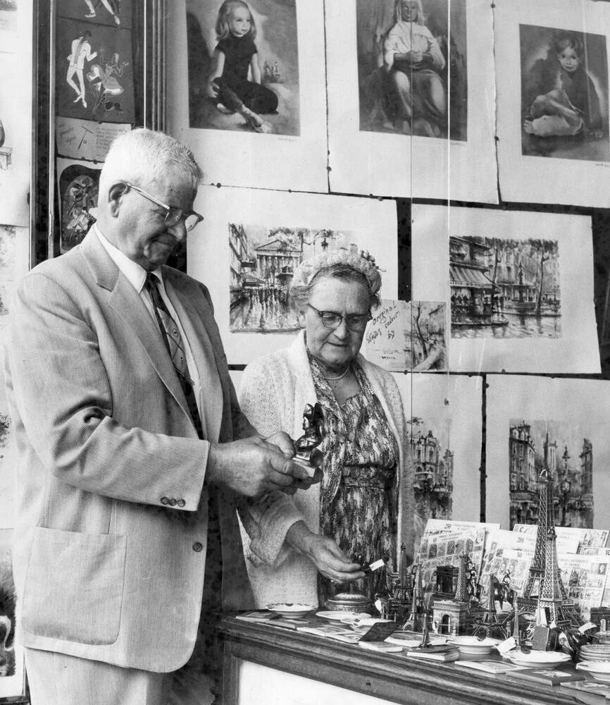 A man and woman viewing items in a shop.