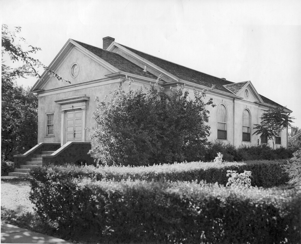 front and side of one-story stucco church building