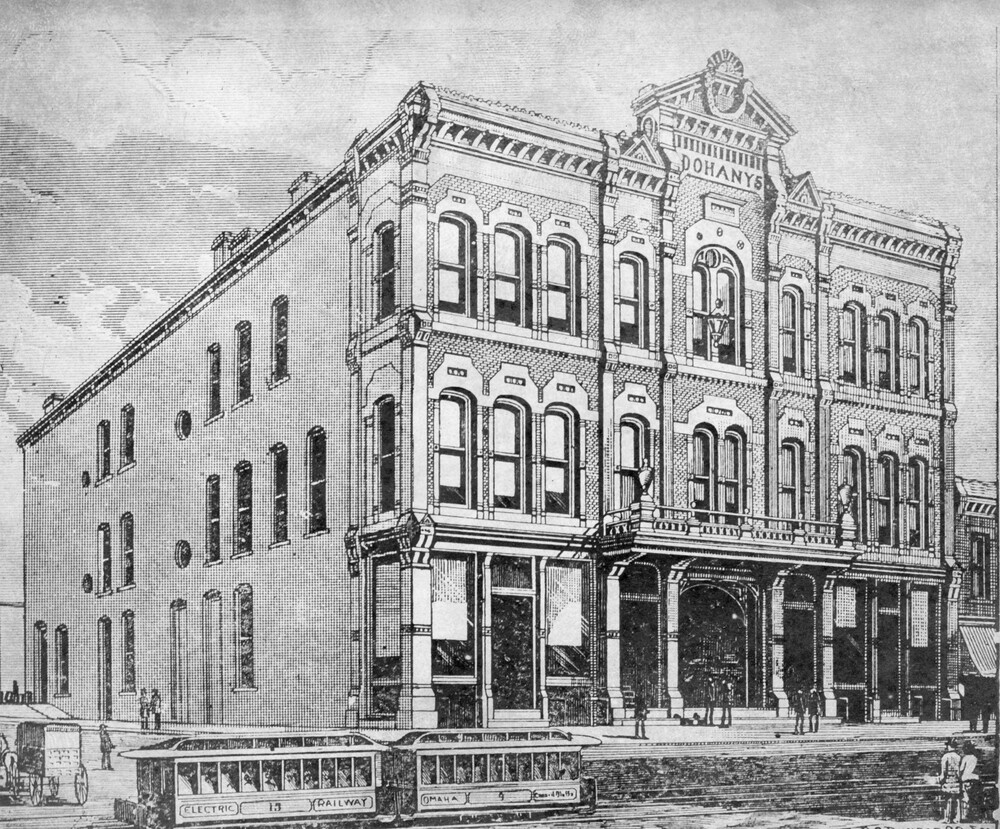 Engraving of old,  three-story brick building with two streetcars running in front of building.