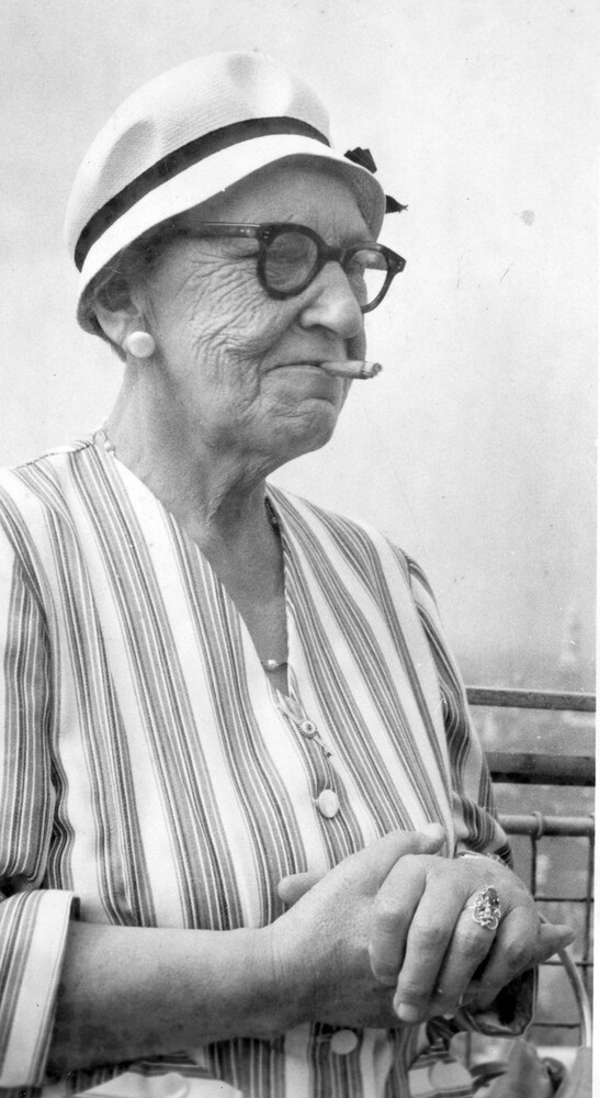 A woman with a cigar in her mouth.