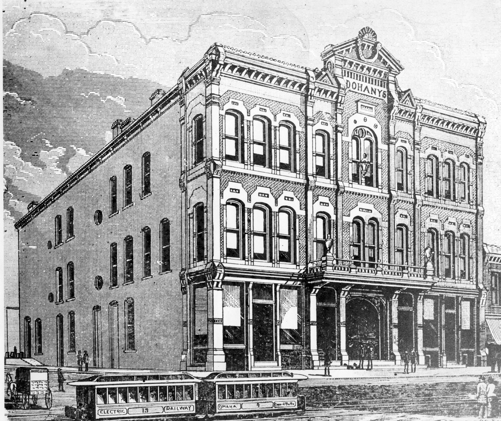 Engraving of old,  three-story brick building with two streetcars running in front of building.