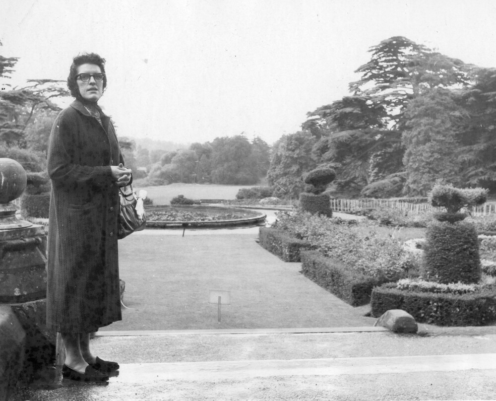 Woman viewing a formal garden.