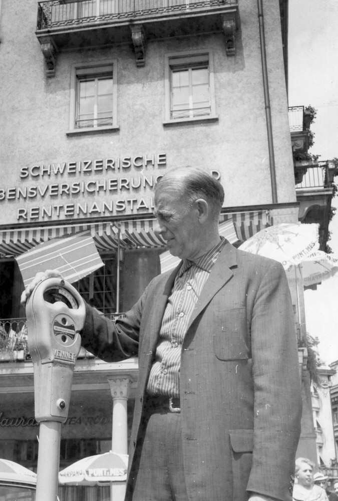 A man viewing a parking meter.