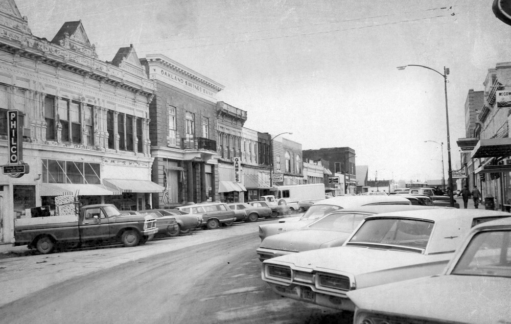 Angle-parked cars next to main street buildings.