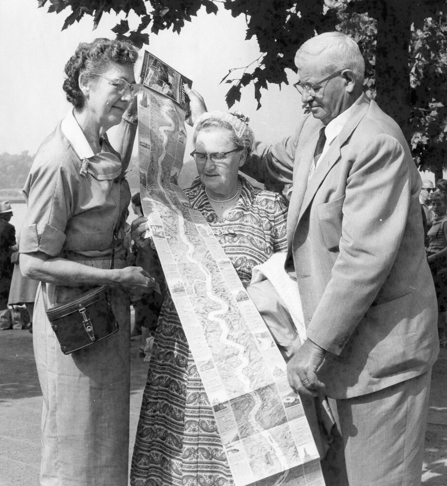 Three people viewing a map.