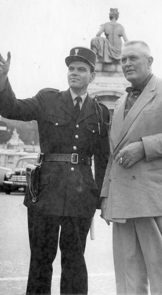 A policeman directing a man on a street.