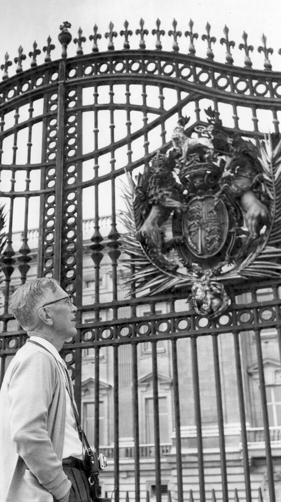 Man viewing an ornate gate.