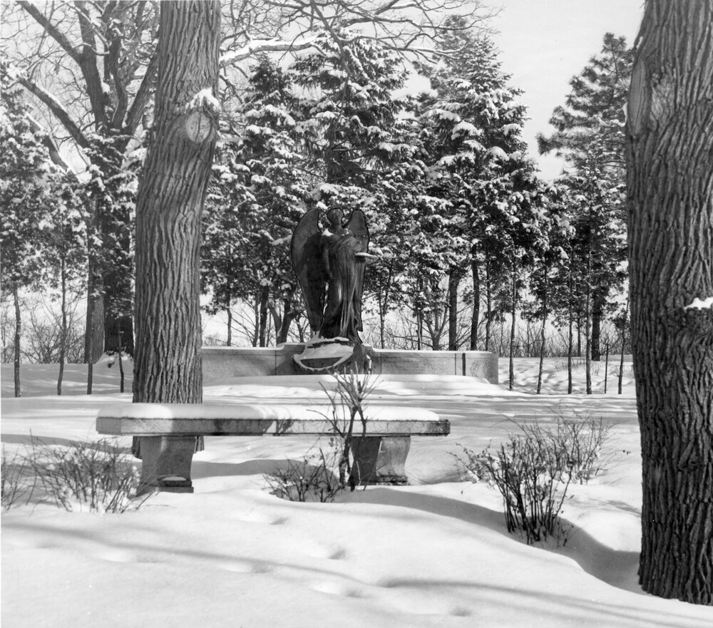 large statue of angel in winter landscape