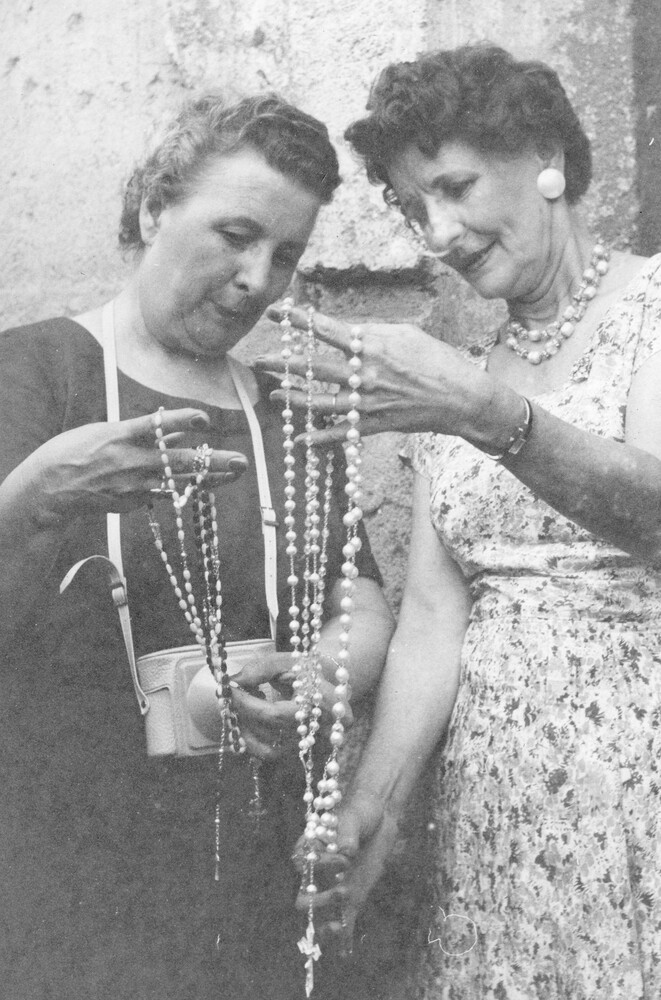 Two women holding rosaries.