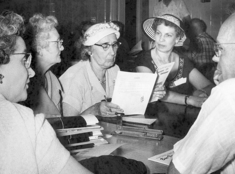 A man and 4 women sitting at a table.