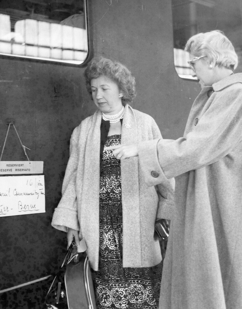Two women reading a sign.