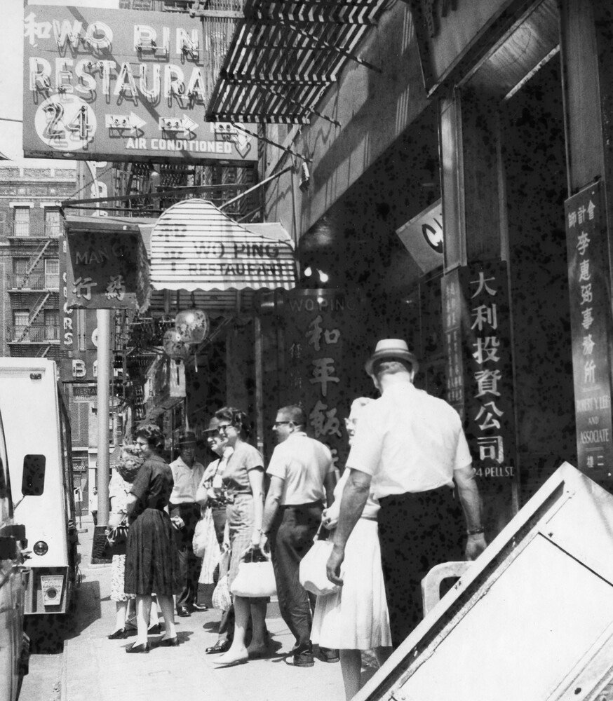 A group of tourists on a busy street.