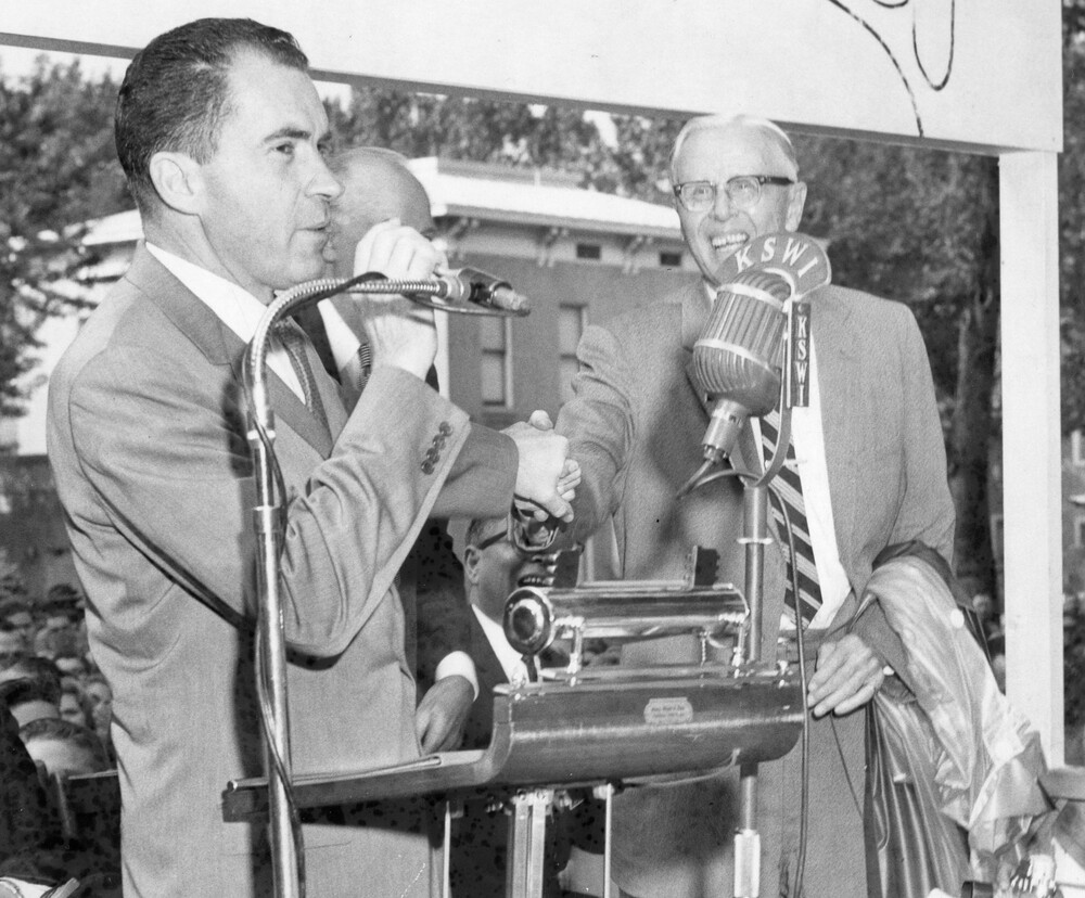 Three men at a podium.