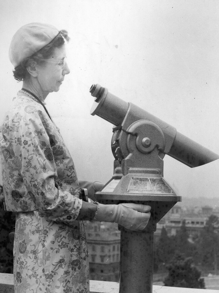 Woman looking at telescope.