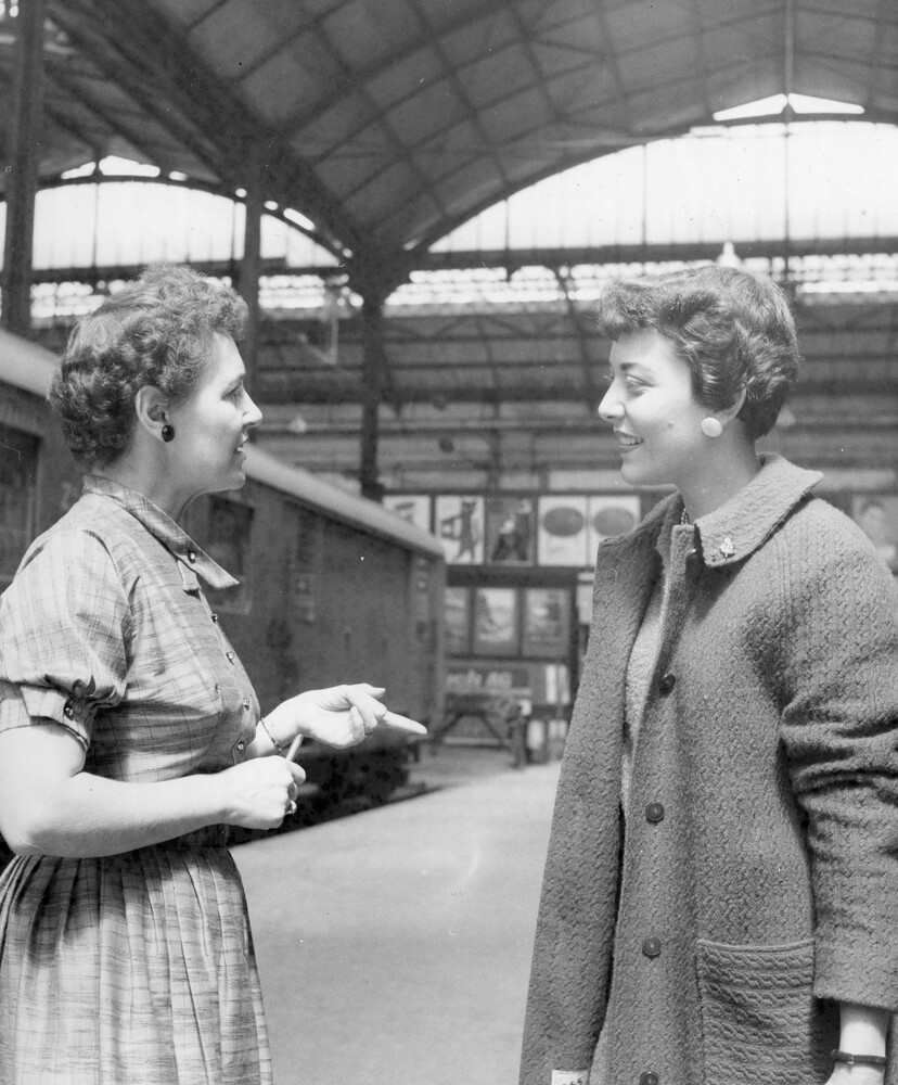Two women speaking.