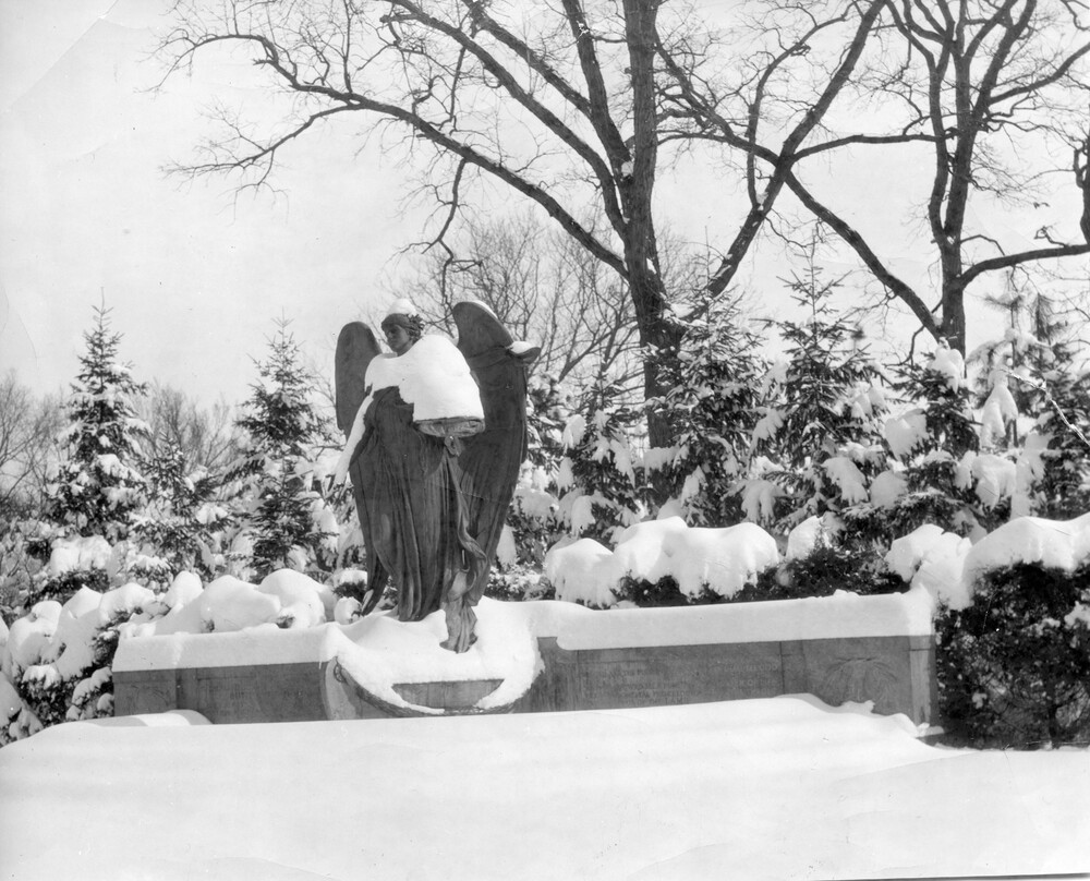 large outdoor statue of an angel covered in snow