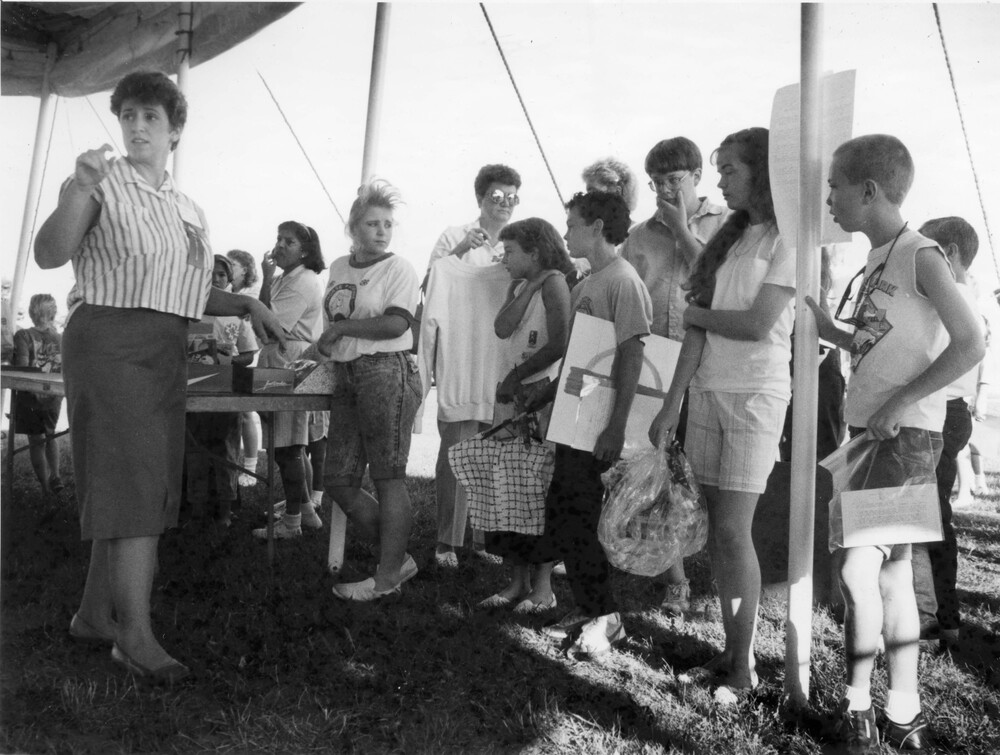 photo of people standing under large outdoor tent
