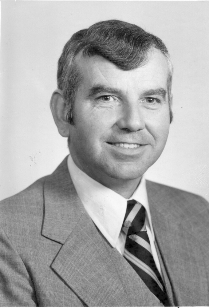 Head shot photo of man in suit and tie