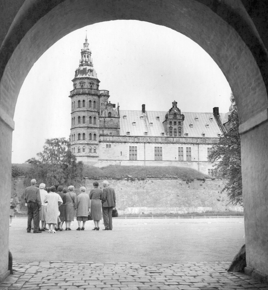 A group of tourist view a castle.