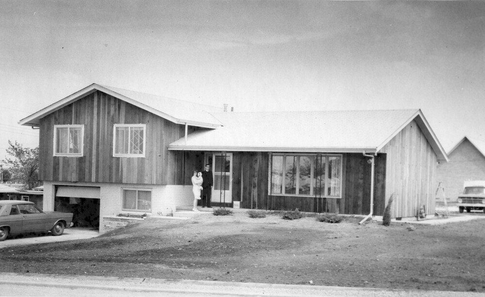 A family standing on the front porch of their home.