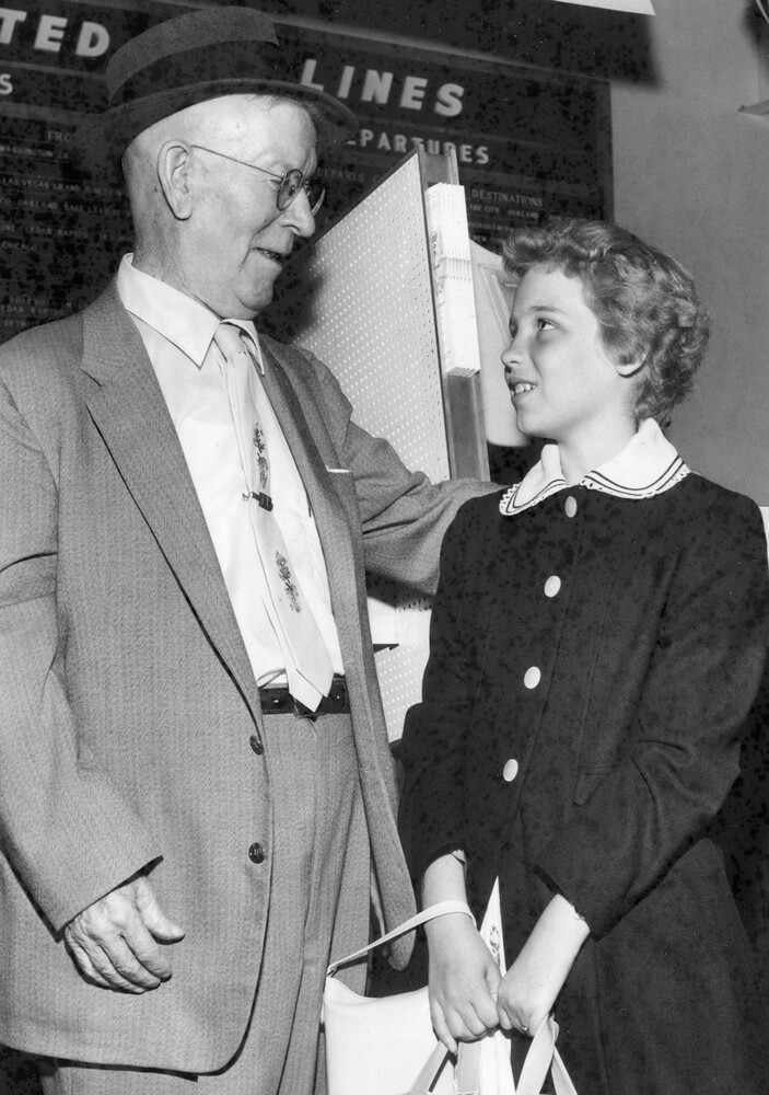An older man looking at a young girl.