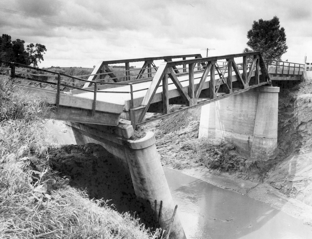 Damaged bridge over a creek.