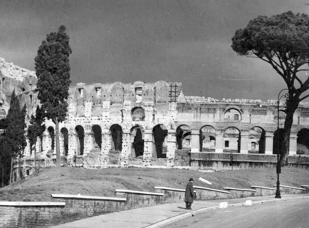 A man walks near the ruins of public baths.