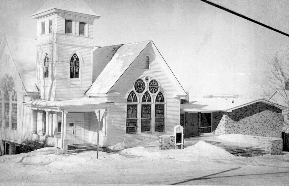 A church building with snow-covered grounds.