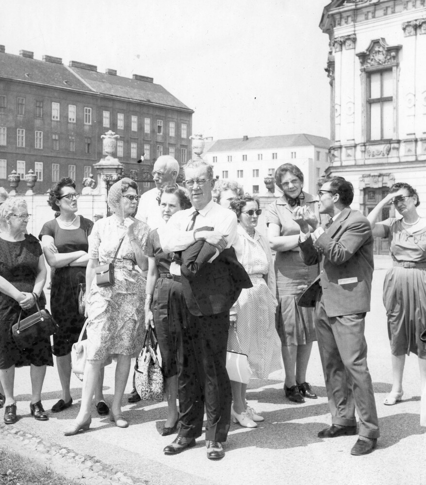 A group of people on a sidewalk.