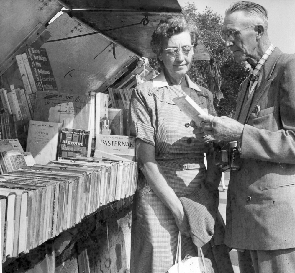 A man and woman looking at books.
