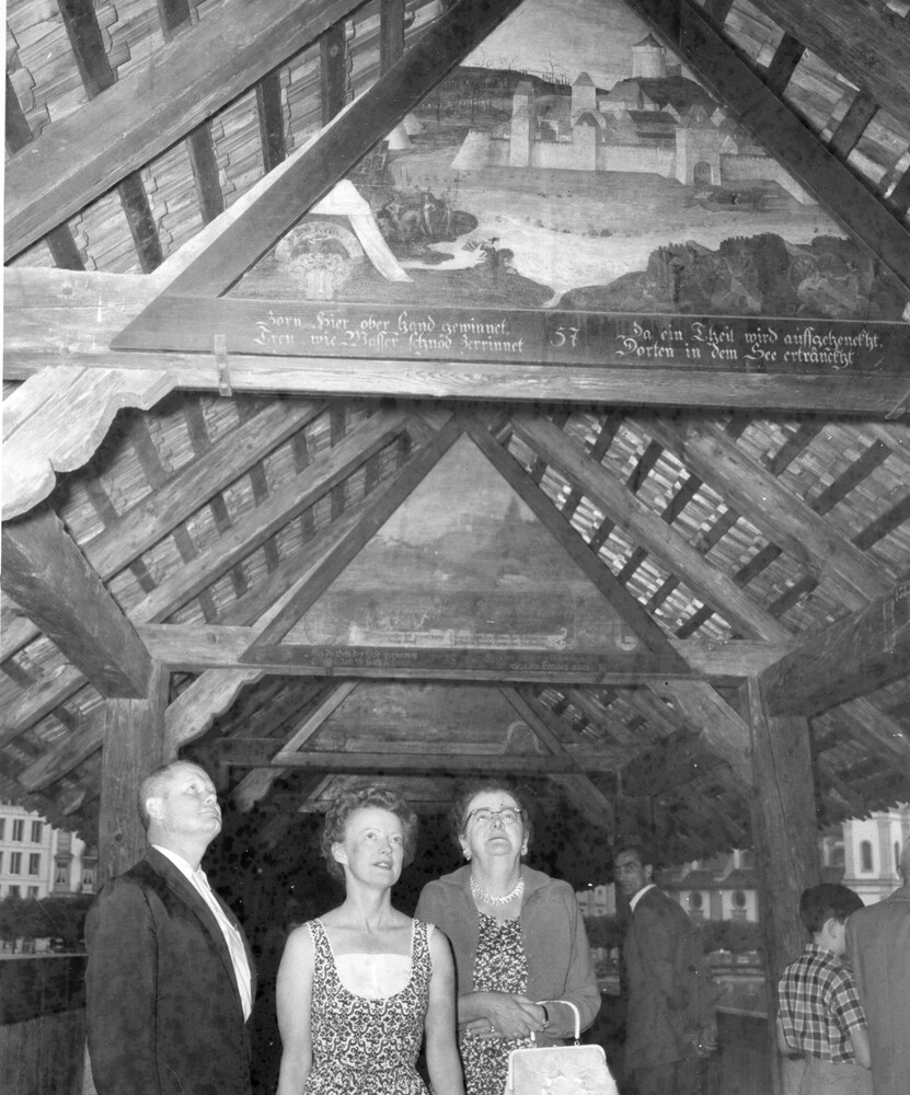 Three people viewing a ceiling.