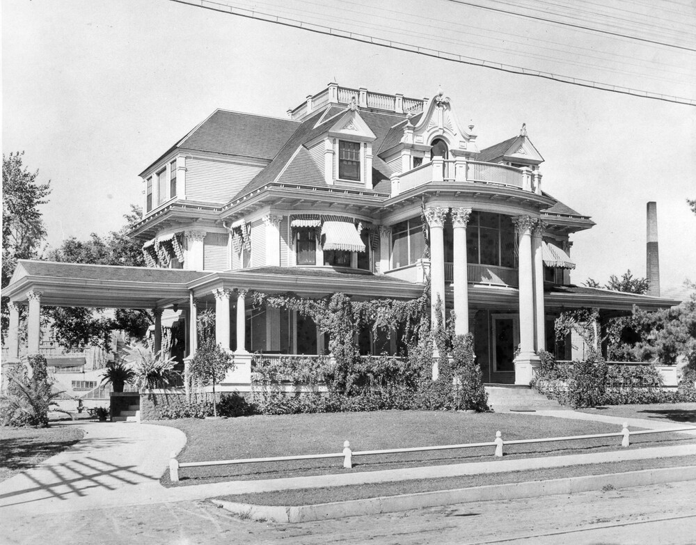 Photo of 3-story mansion with 2-story columns, and a portico
