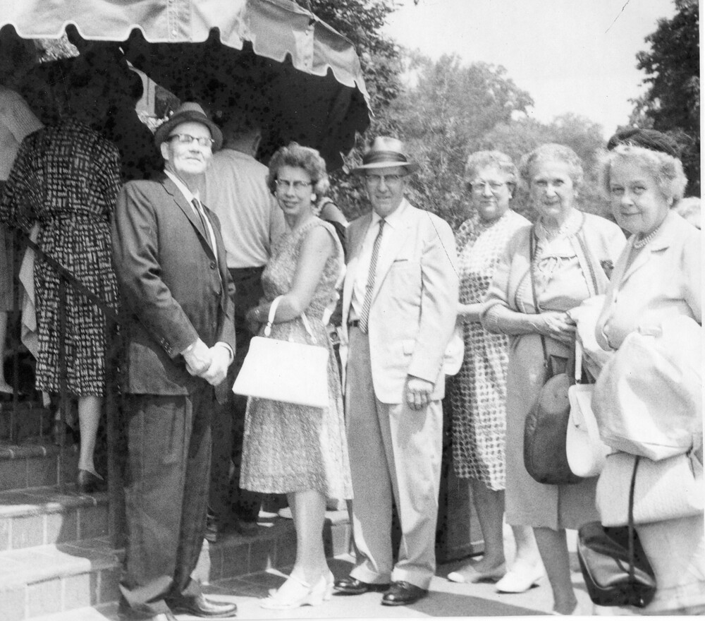 A group of six adults posing for the camera.