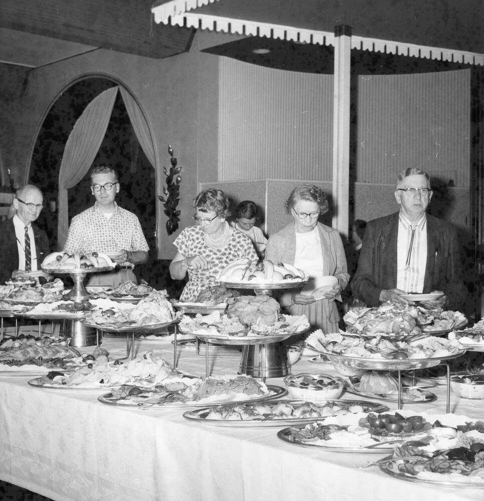 A group of people at a buffet table.