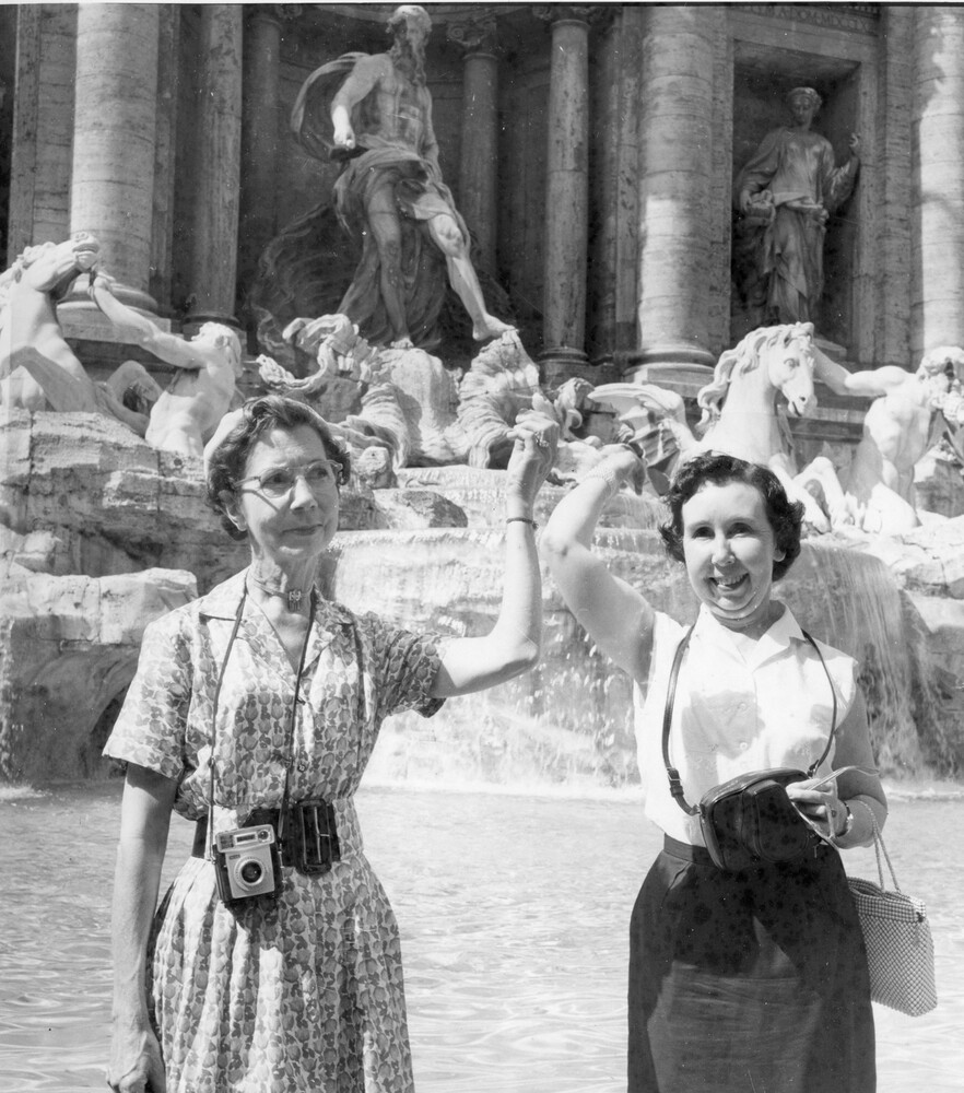 Two women in front of a fountain.