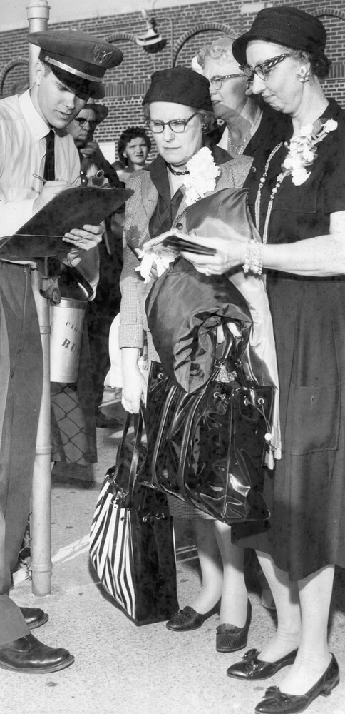Two women checking in at an airport.