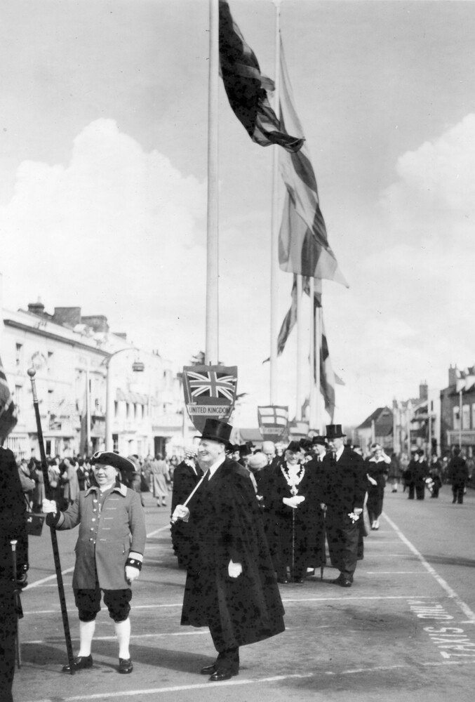 Flags fluttering above a group of men.