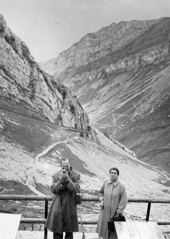 A man and woman with mountains in the background.