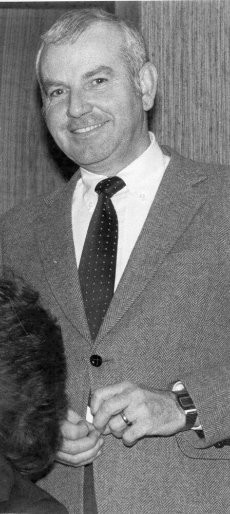 Photo of smiling man in a suit