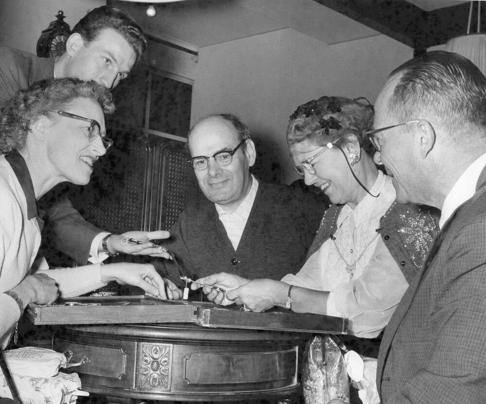 People viewing items on a table.