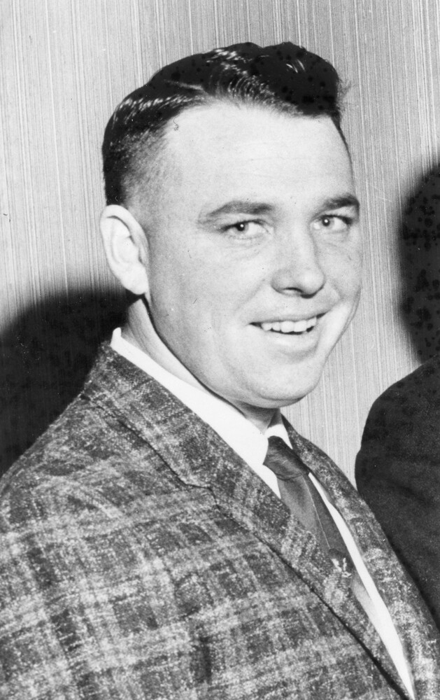 Head and shoulders photo of smiling man in suit and tie